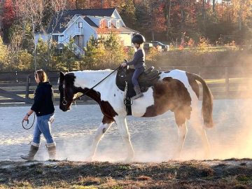 child riding a horse at Redbird Equestrian